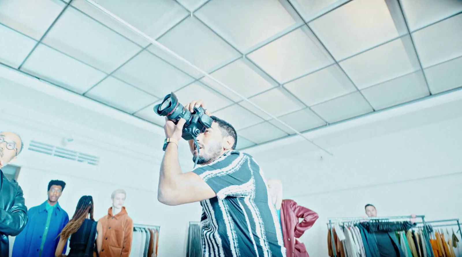 a man is taking a picture of himself in a clothing store