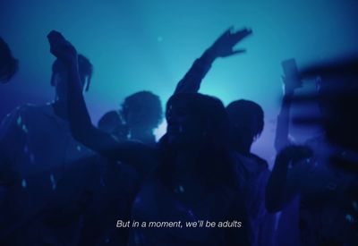 a group of people dancing in a dark room