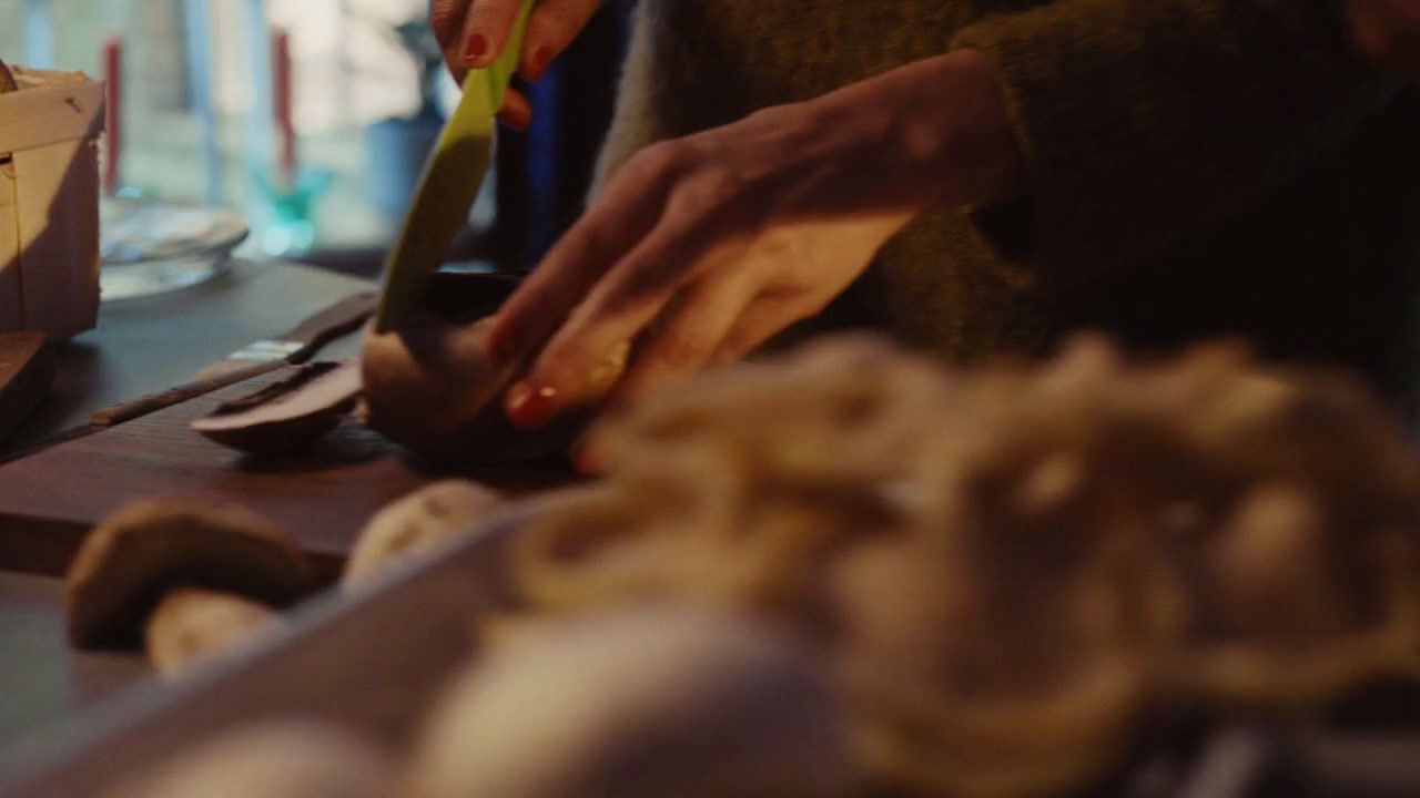 a person cutting food on a cutting board