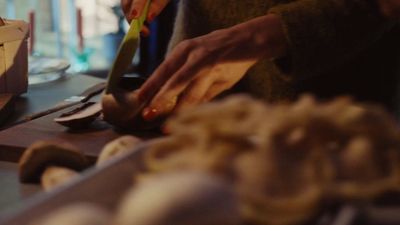 a person cutting food on a cutting board