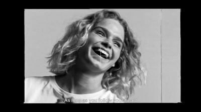 a black and white photo of a woman laughing