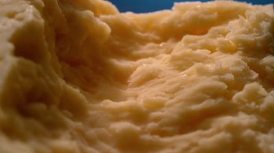 a close up of mashed potatoes on a blue plate