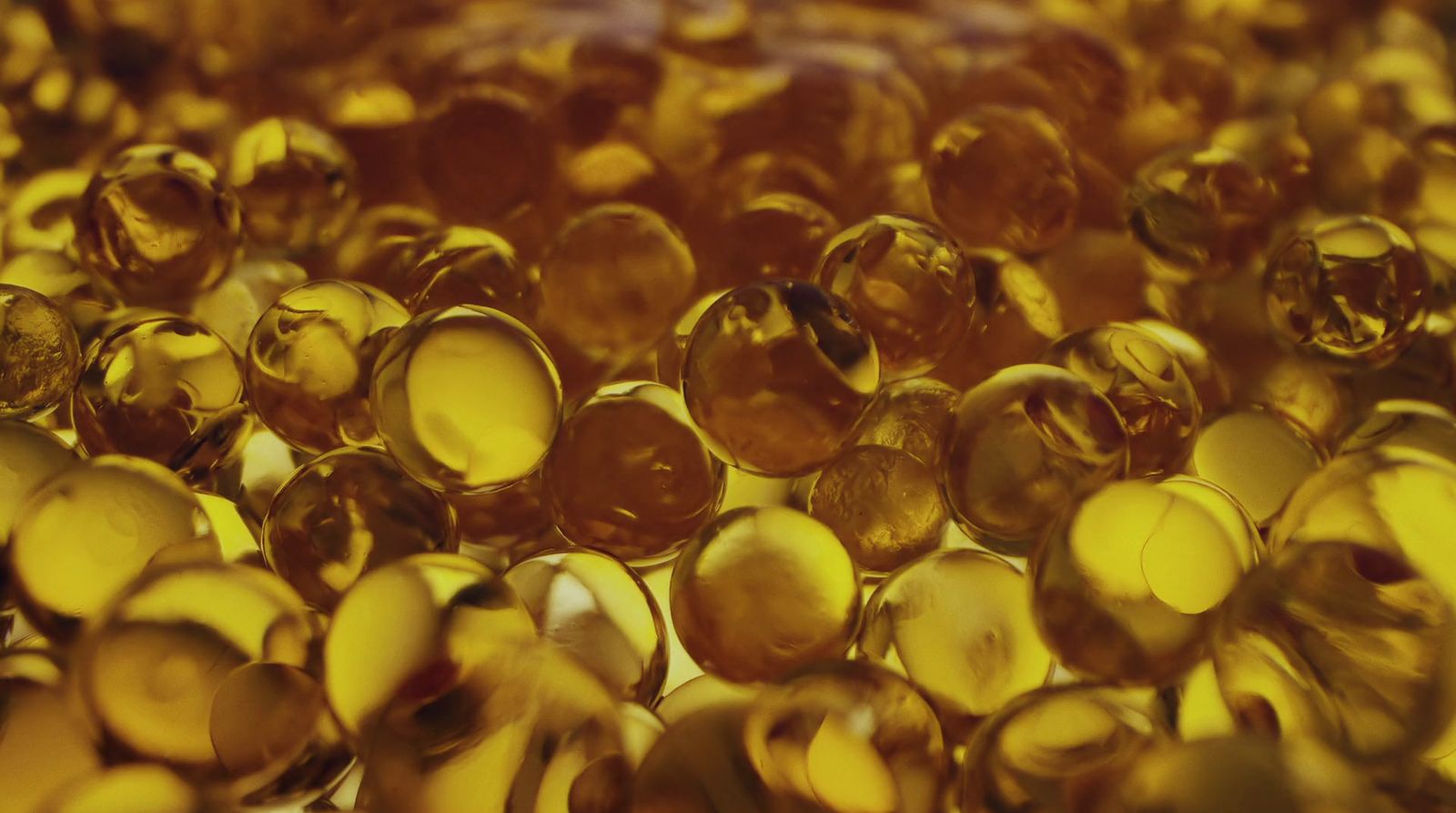 a close up of a bunch of yellow glass beads