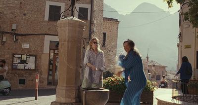 a couple of women standing next to each other on a street