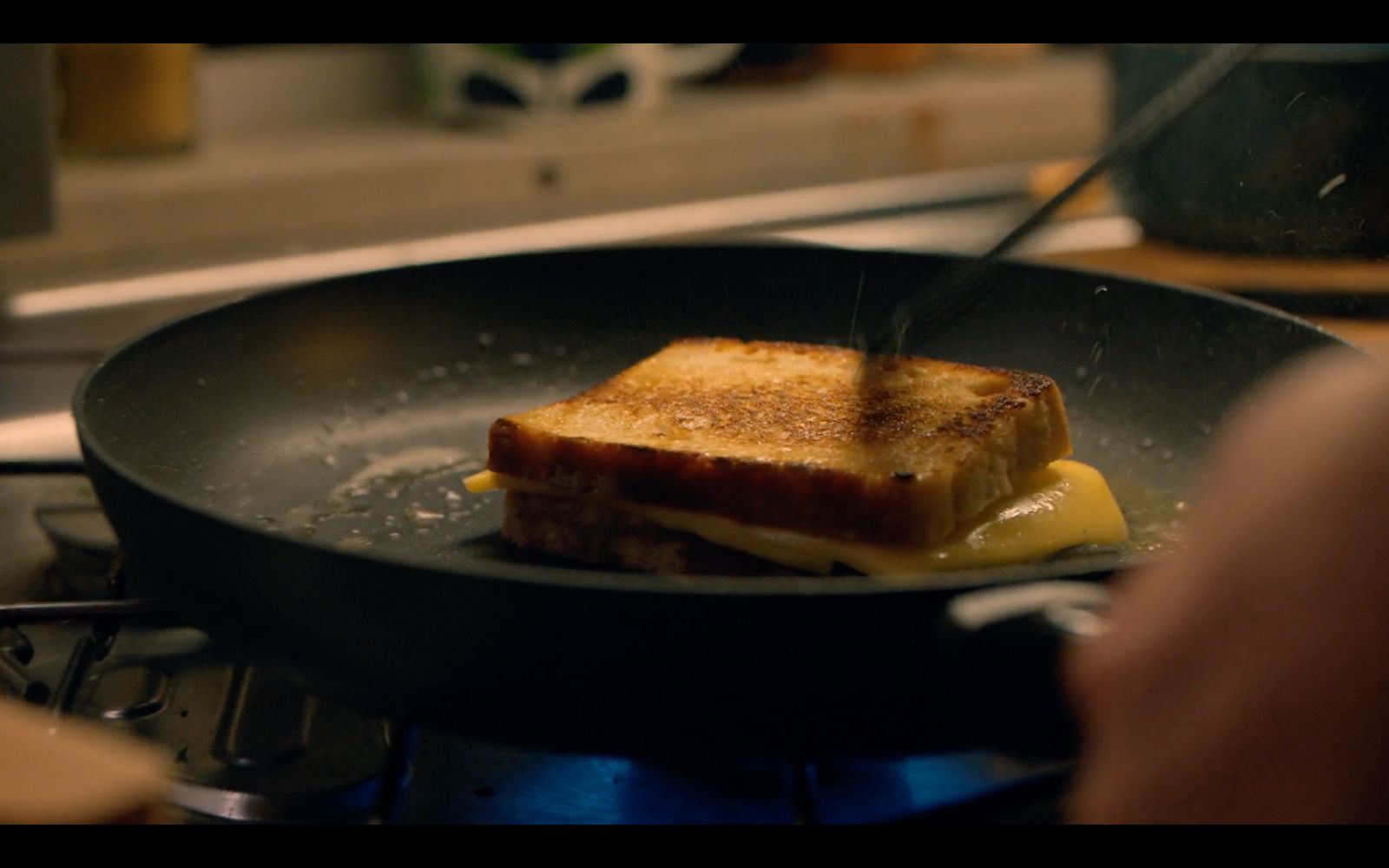 a grilled cheese sandwich is being cooked in a skillet