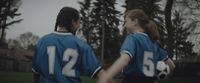 a couple of women standing next to each other holding hands