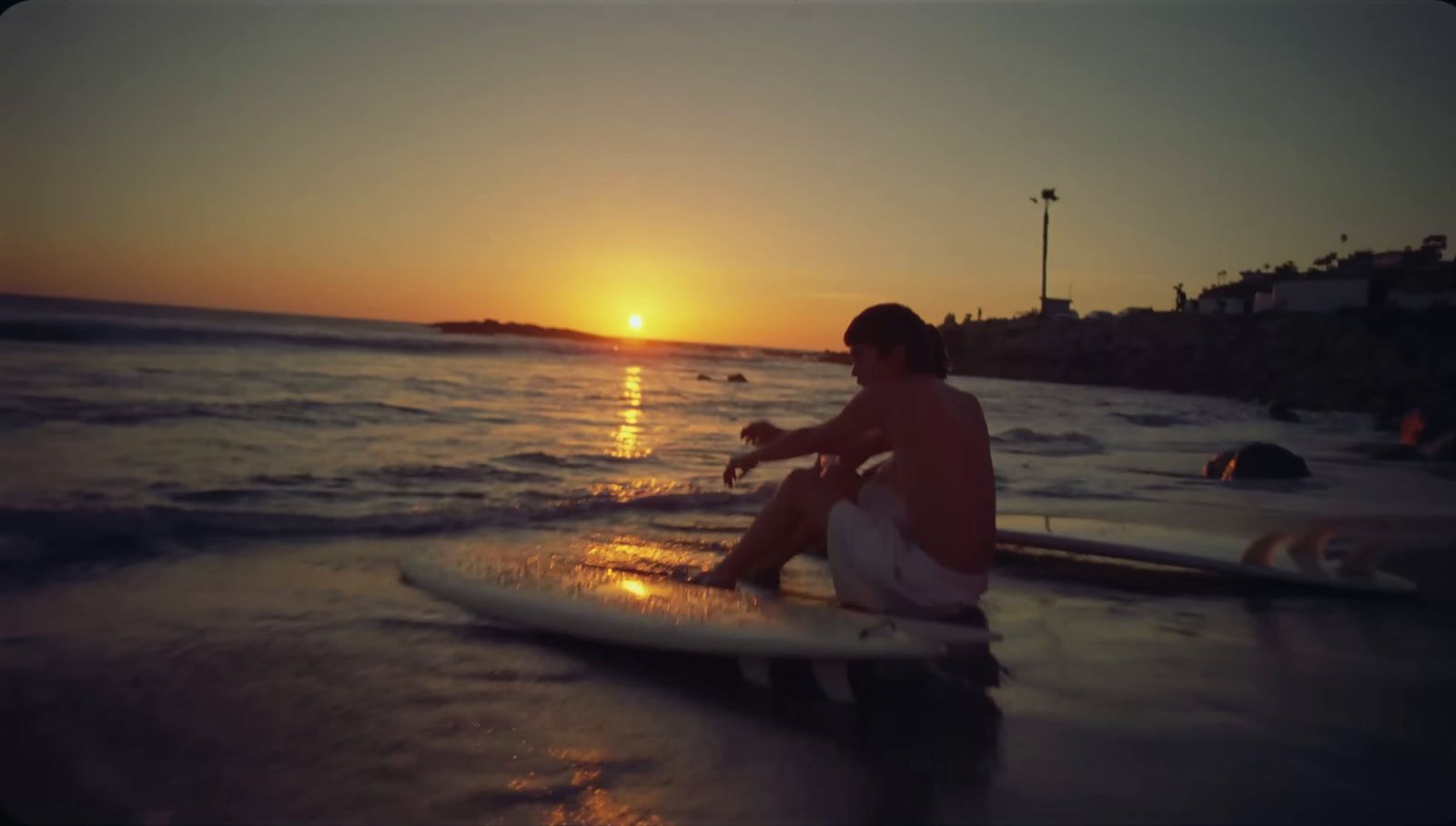 a man riding a surfboard on top of a body of water