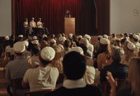 a crowd of people sitting in front of a podium