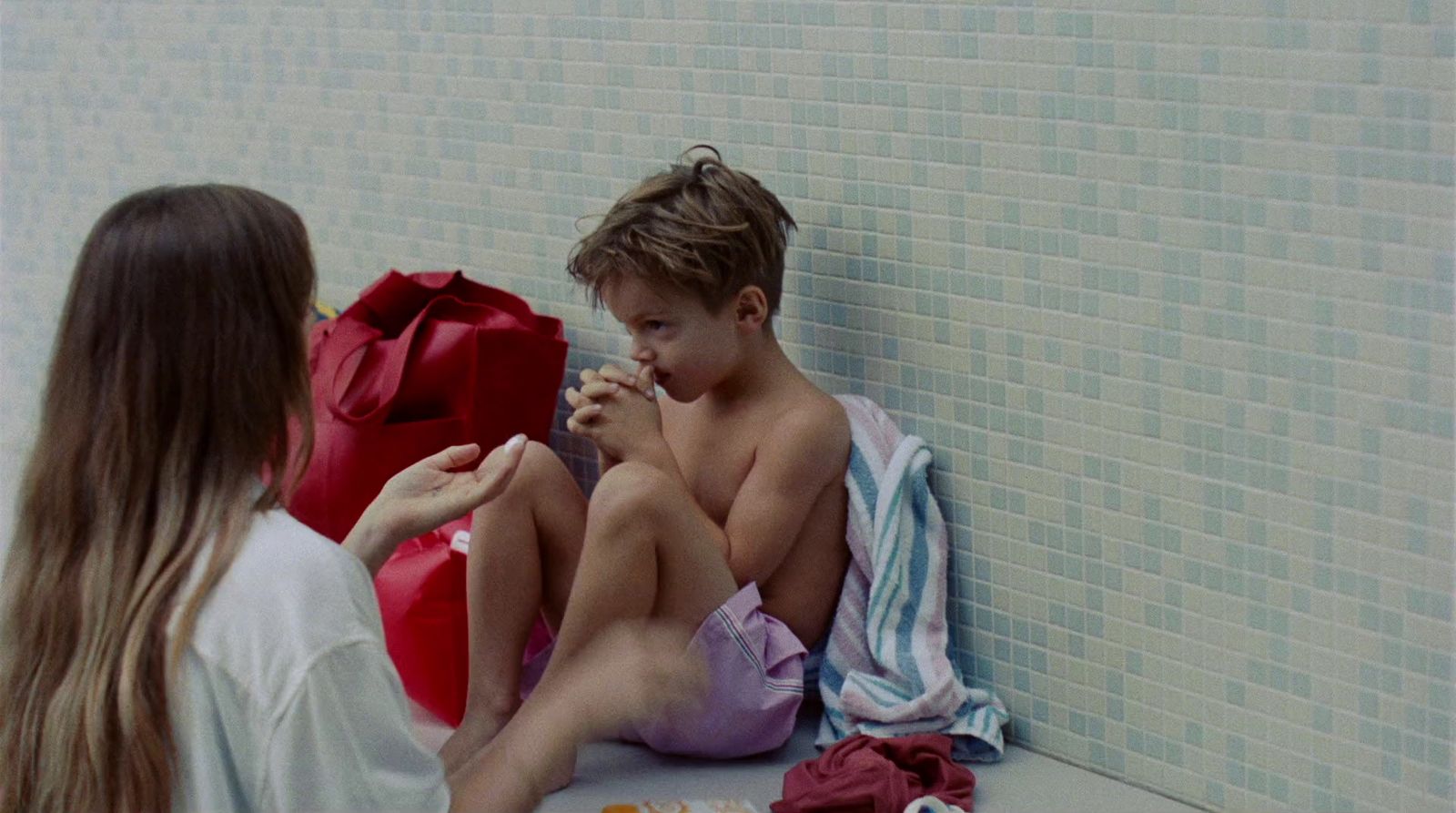 a boy and a girl sitting on the floor next to each other