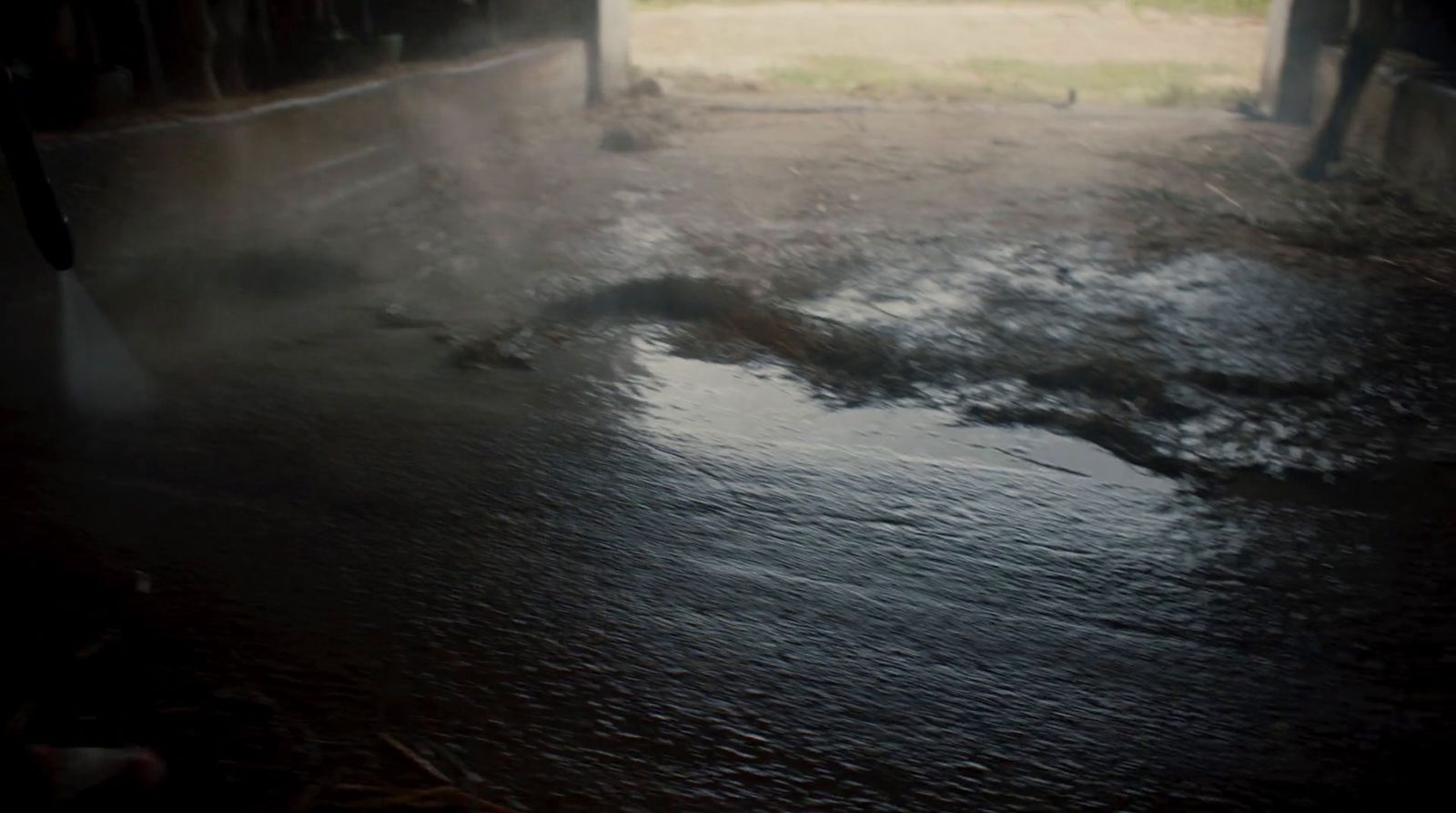 a fire hydrant spewing water out of a puddle