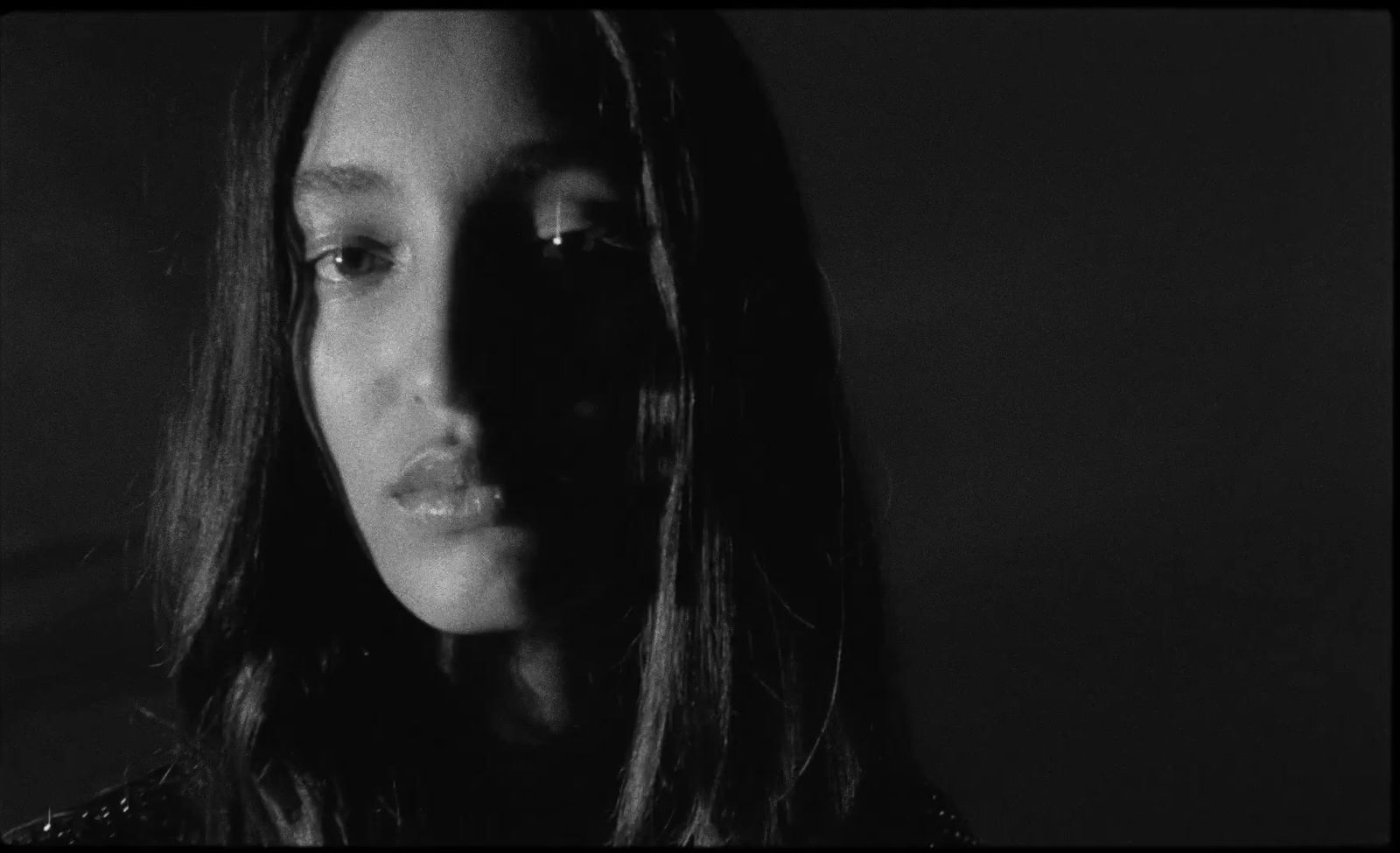 a black and white photo of a woman with long hair