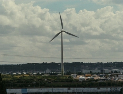 a wind turbine in the middle of a field