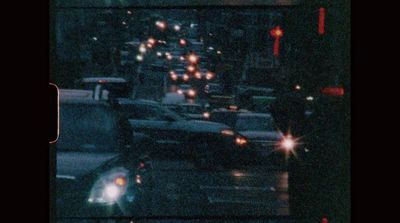 a city street filled with lots of traffic at night