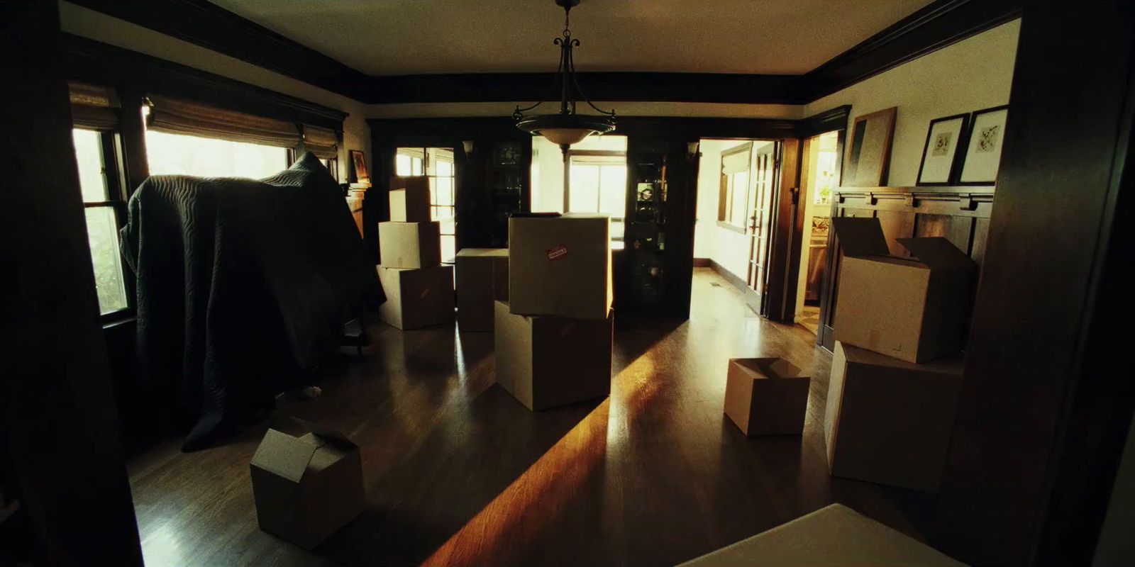 a living room filled with boxes and furniture