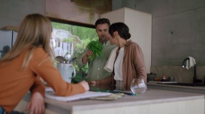 a man and a woman standing in a kitchen