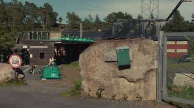 a large rock sitting in front of a building