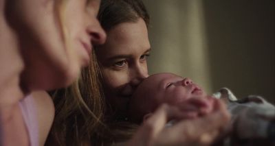 a woman holding a baby in her arms