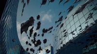 a group of graduates throwing their caps in the air