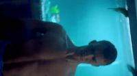 a man standing in front of a fish tank