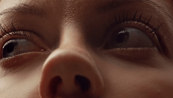 a close up of a woman's nose with a nose ring