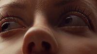 a close up of a woman's nose with a nose ring
