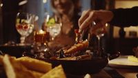 a woman sitting at a table with a plate of food