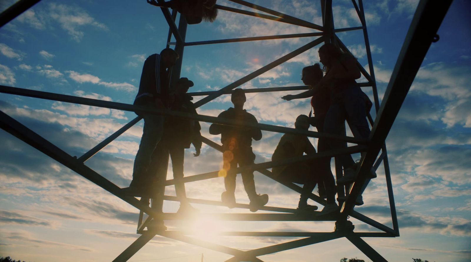 a group of people standing on top of a metal structure