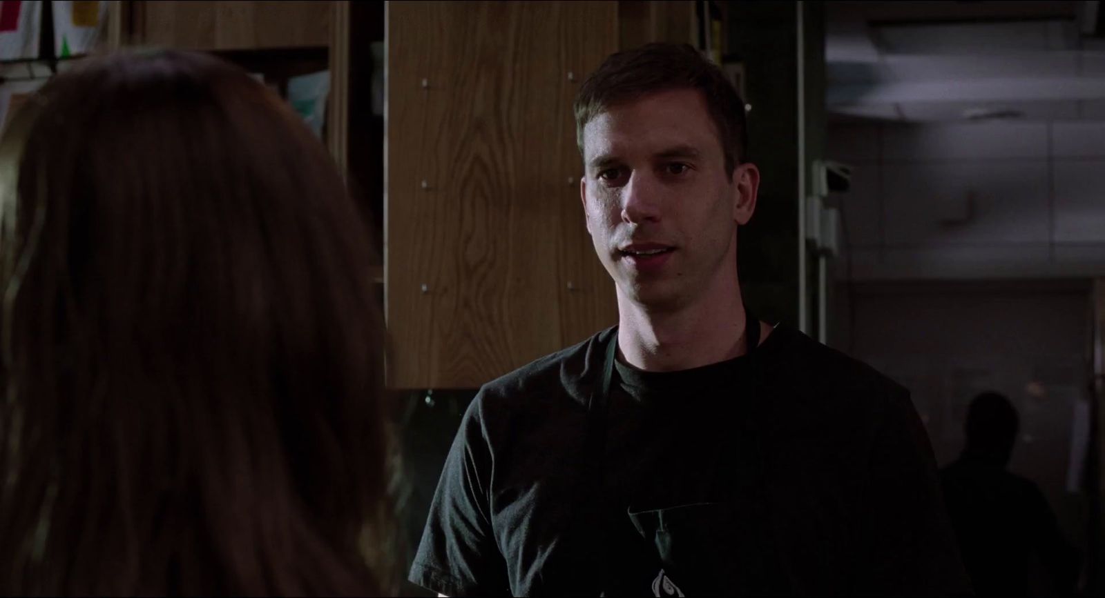 a man standing next to a woman in a kitchen