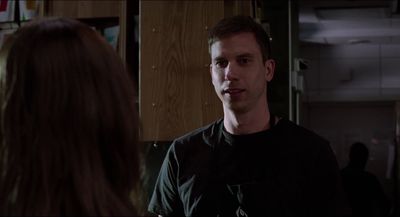 a man standing next to a woman in a kitchen