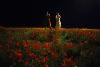 two women standing in a field of flowers