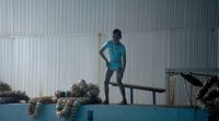a statue of a boy standing on top of a swimming pool