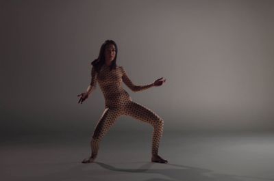 a woman in a leopard print body suit