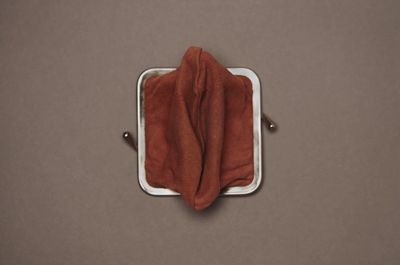 a square object with a brown cloth on top of it