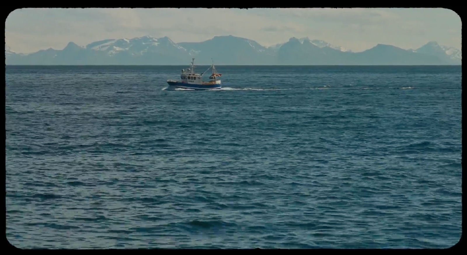 a small boat in the middle of a large body of water