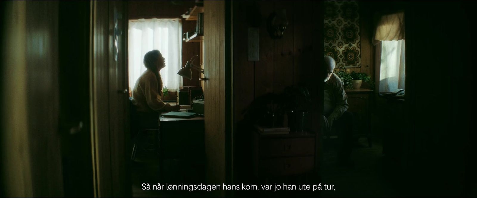 a woman standing in a kitchen next to a window