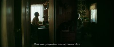 a woman standing in a kitchen next to a window