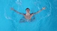 a man swimming in a pool with his arms outstretched