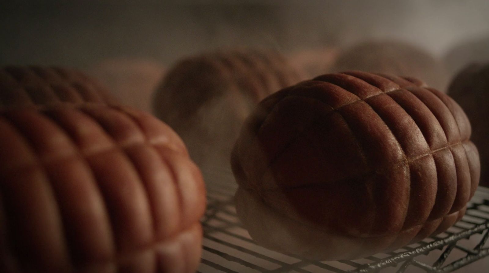 a bunch of doughnuts sitting on a wire rack