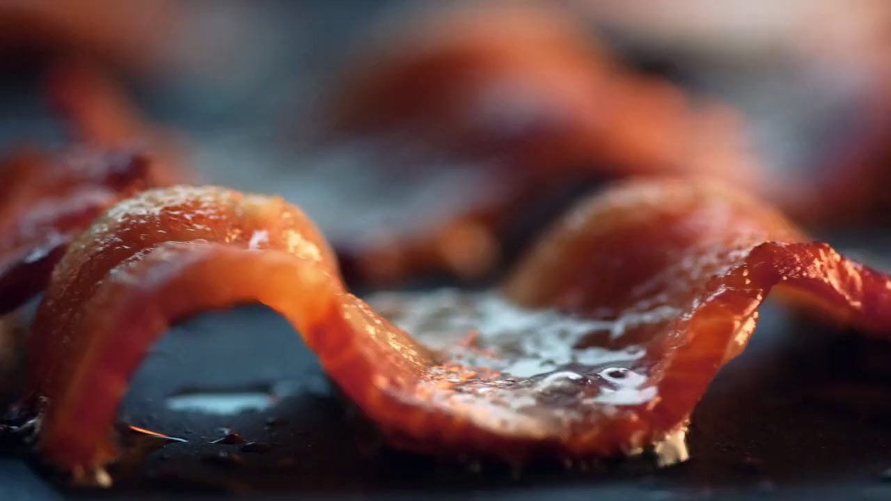 a close up of bacon on a plate