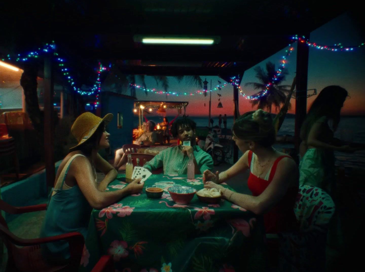 a group of women sitting around a green table