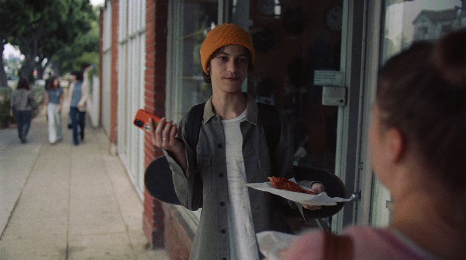 a woman holding a plate of food in front of a store