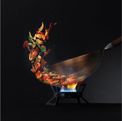 a wok with food being cooked on it