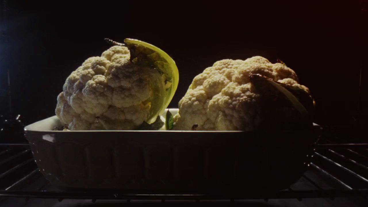 two scoops of ice cream in a bowl on an oven rack