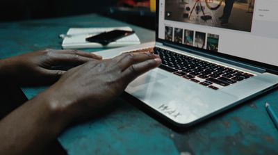 a person using a laptop computer on a table