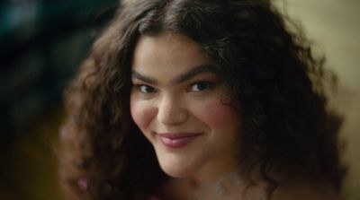 a close up of a person with curly hair