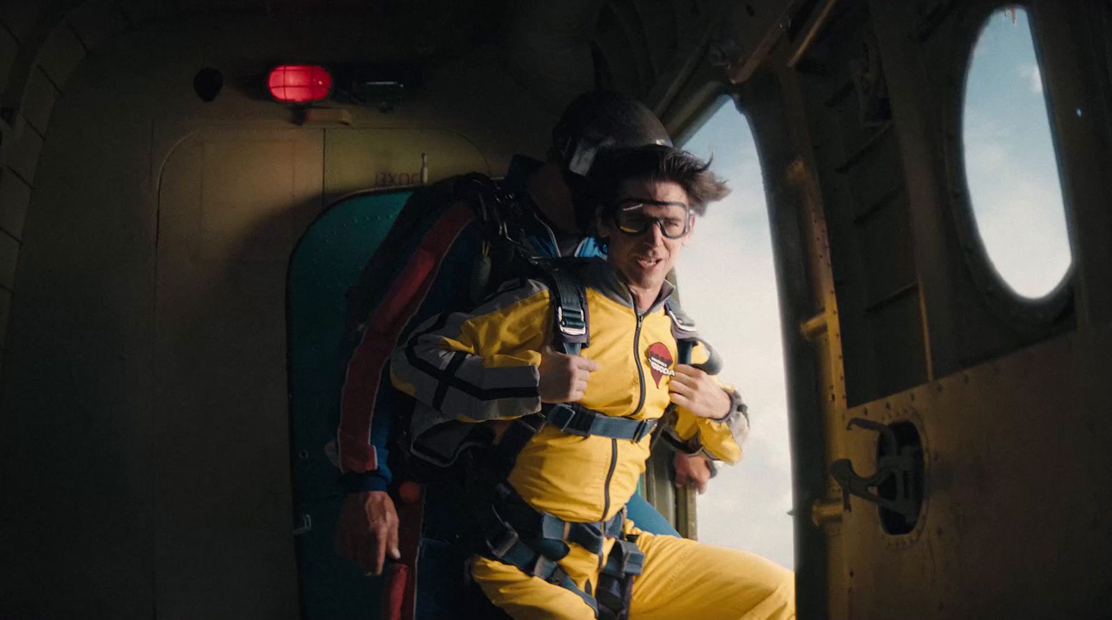 a man in a yellow and black wet suit and goggles