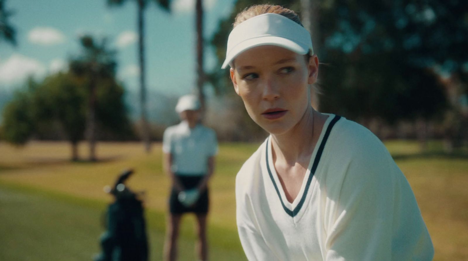 a woman holding a tennis racquet on a tennis court