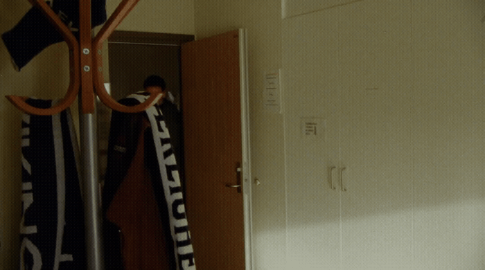 a person is holding a scarf in a room