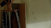 a person is holding a scarf in a room