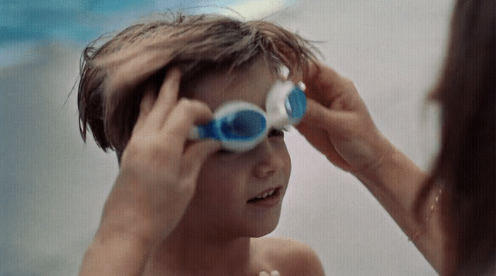 a little boy that is brushing his hair